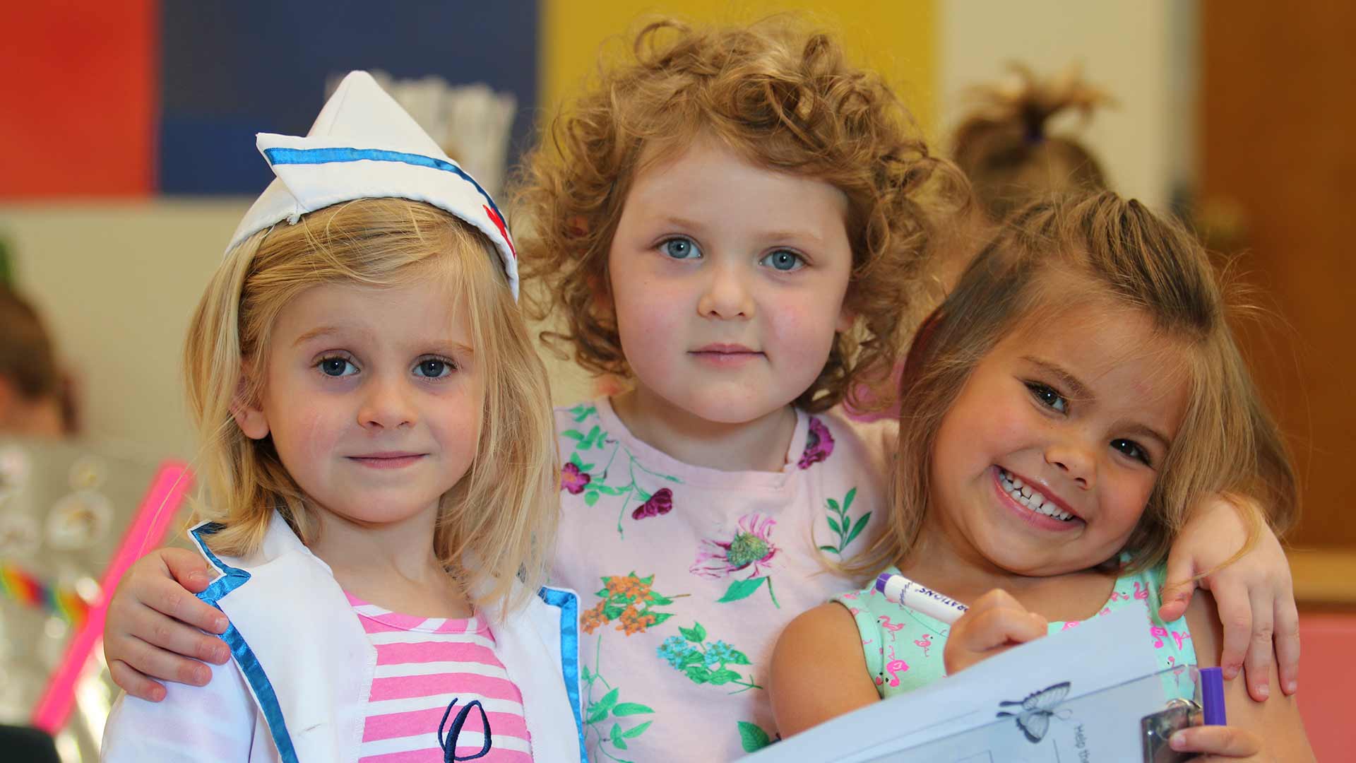 Three young TTWS friends smiling together